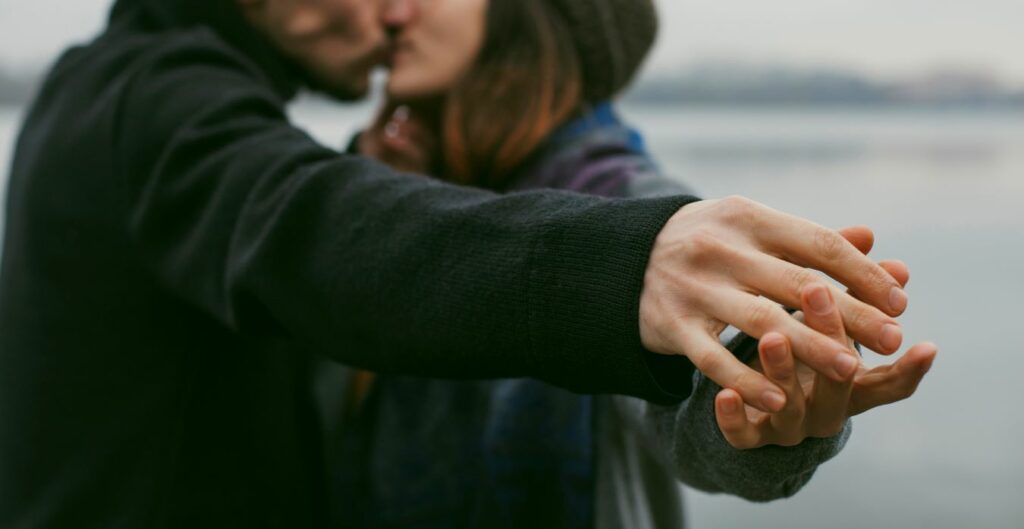 couple holding hands and kissing